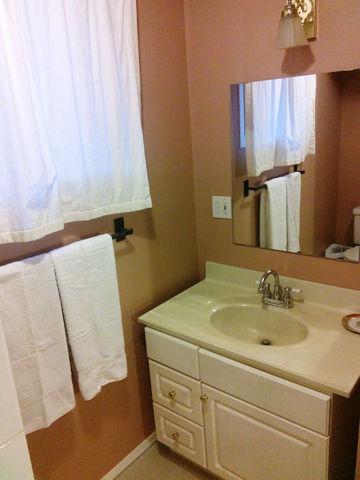 Private bathroom with bath and shower