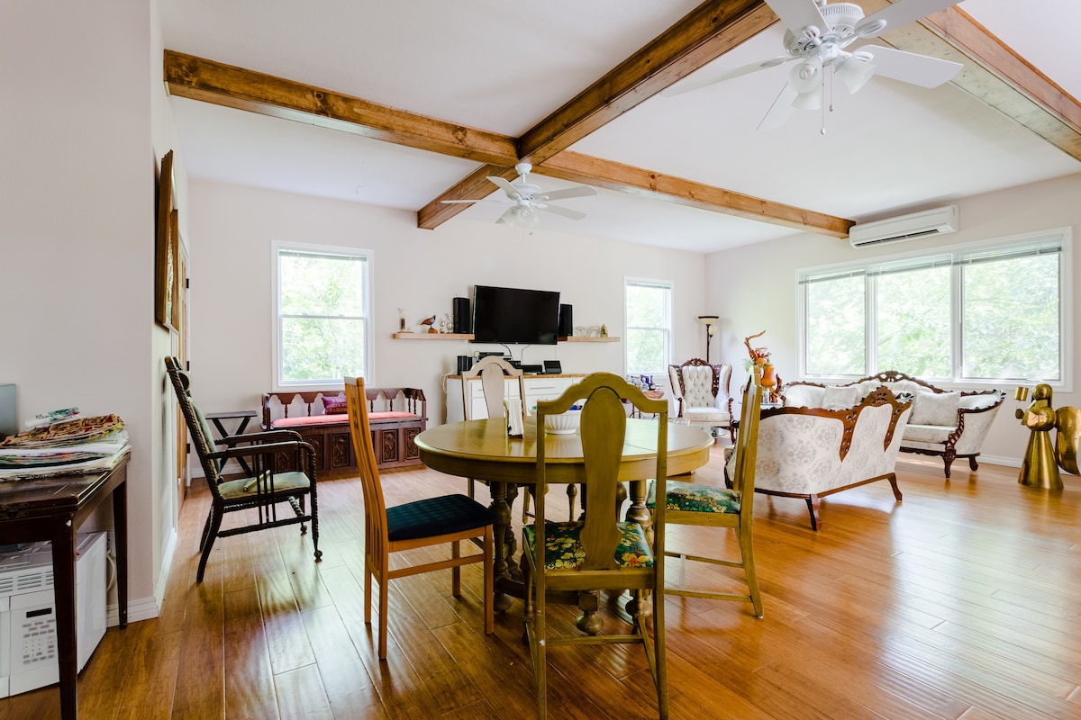 Secluded tree house apartment with high ceilings.