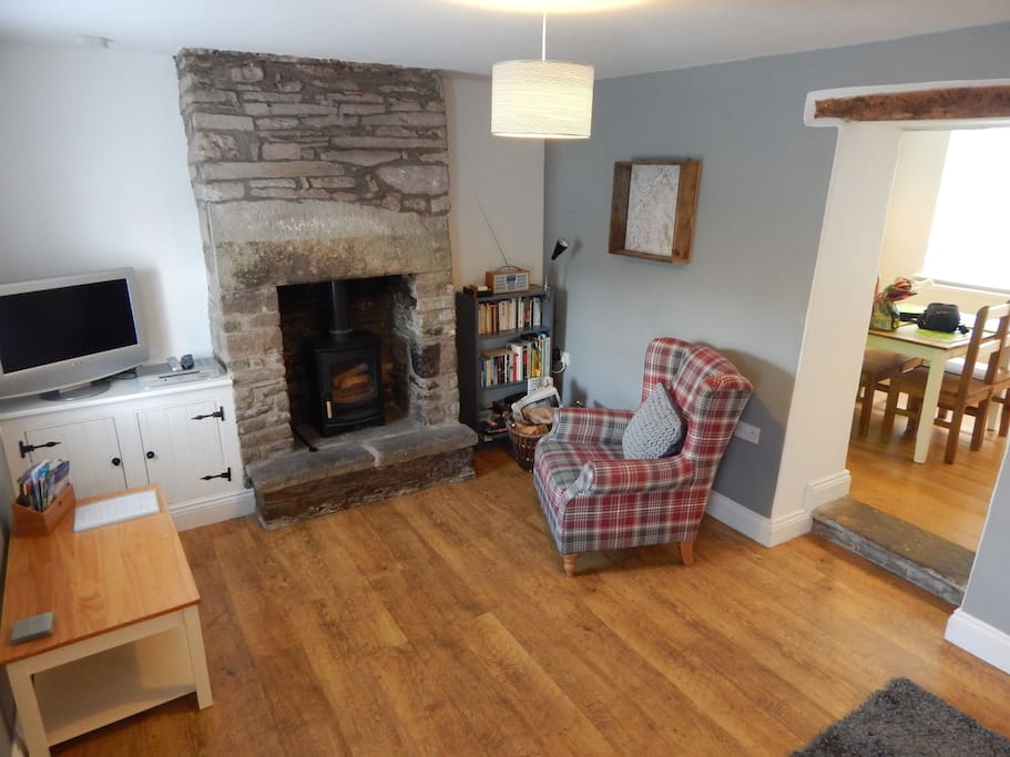 Living room with log burner and comfy armchair