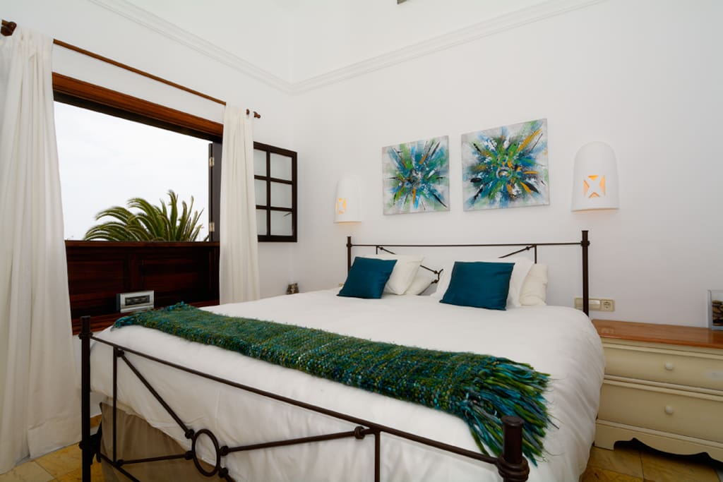 Master bedroom with huge Eastern king size bed leading to rooftop balcony with stunning volcano and ocean views to Fuerteventura.