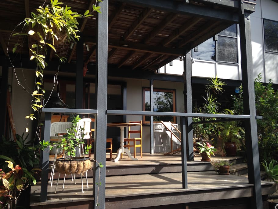 The Cove Studio deck with bifolds opening on to it. A sunny spot in the morning.