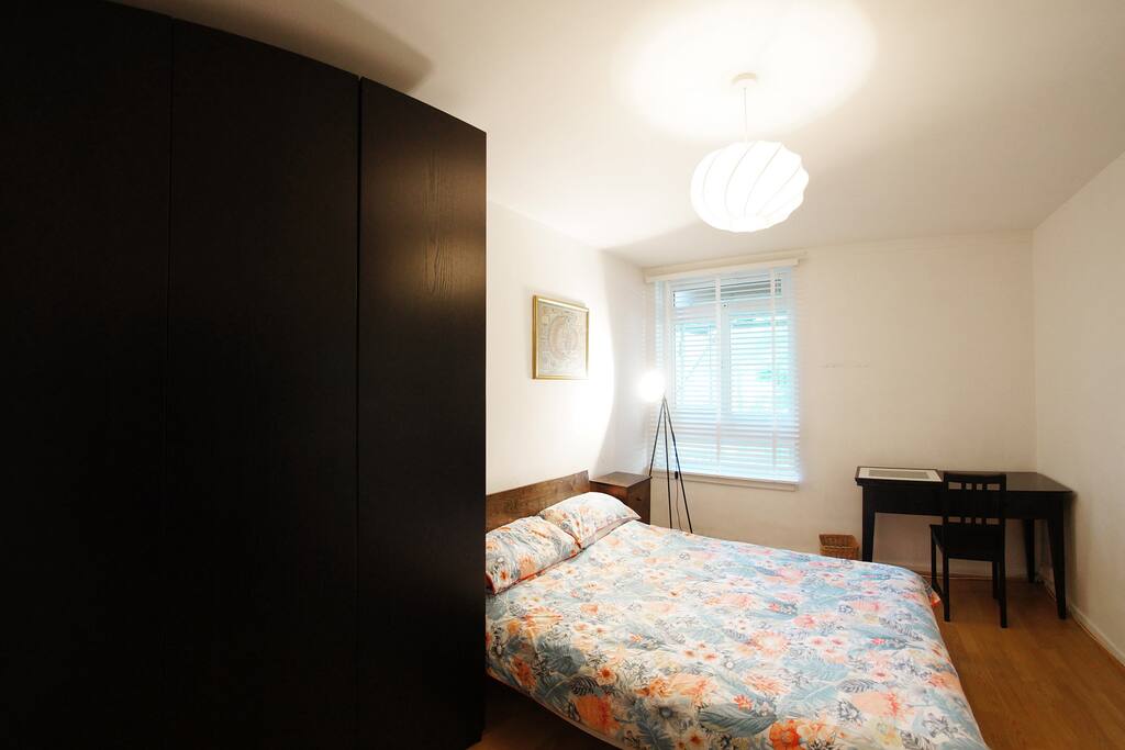 West bedroom with closet and bigger desk.