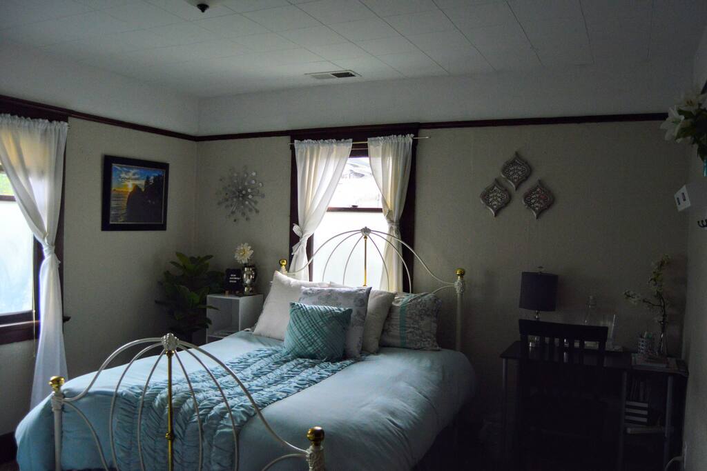 the room includes a desk area, guest stand to the left of the bed (lots of literature on the area, as well as the breakfast voucher). On the desk, we provide a canister of purified water, glasses for each guest, a candle and lamp, as well as a power strip.