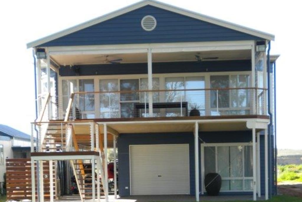 River side of home with large balcony and downstairs teenagers retreat. Balcony has seating for 10, 2 daybeds, patio heater and 2 large flood lights for night time use.