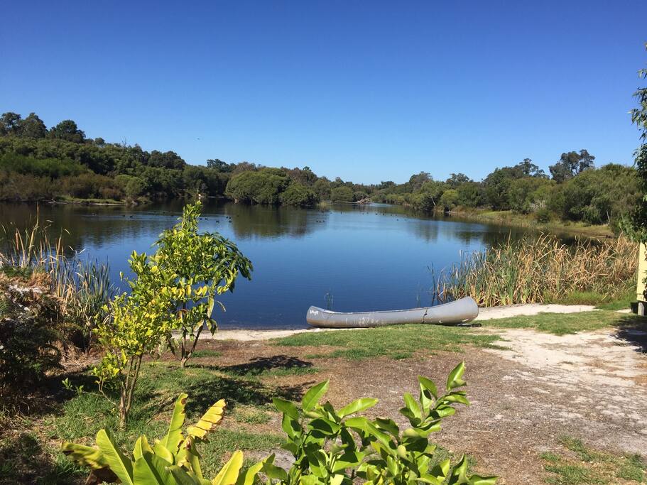 The beautiful lake directly at the rear of the house where a cool little canoe is there for your use