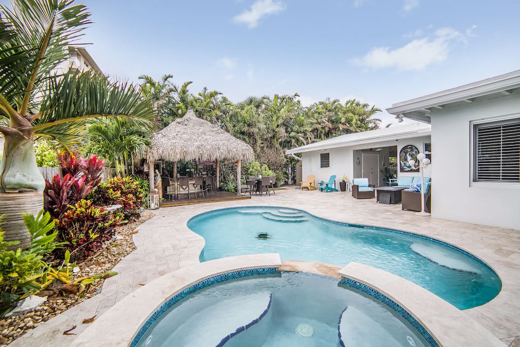 Backyard view of beautiful pool, Tiki Bar and sitting area.