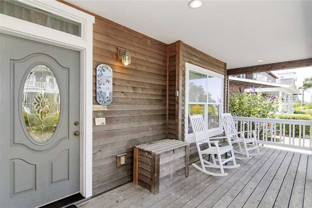 A welcoming front porch with seating to enjoy during your stay.