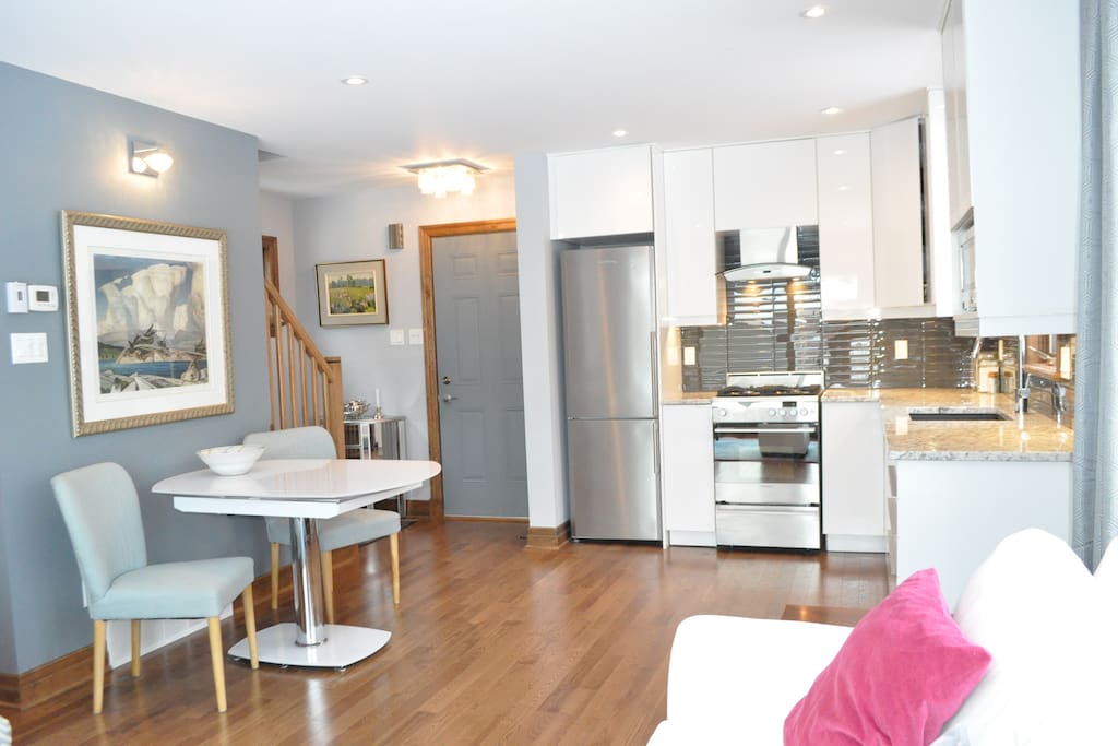 View of the Entry, Kitchen and Dining Area from the Living Room.