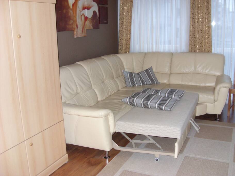 Living room with a kingsize sleeping (opening) corner sofa