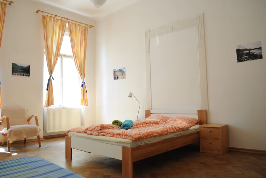 Double bed with small table on every side.