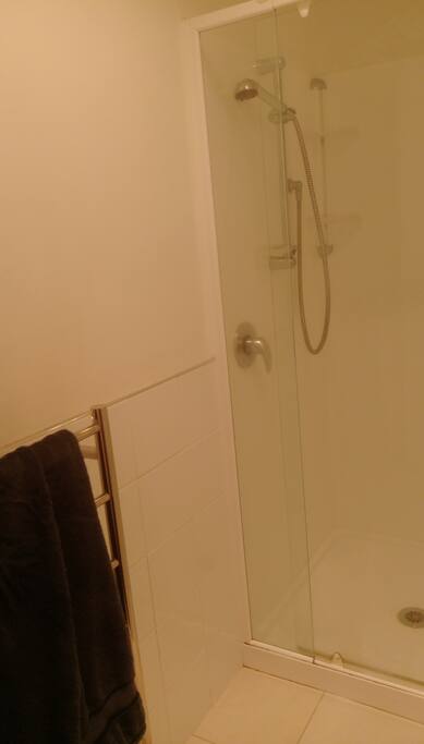 Common bathroom: shower, toilet and bath tub + sink in three separate rooms. Includes towels, soap + shampoo
