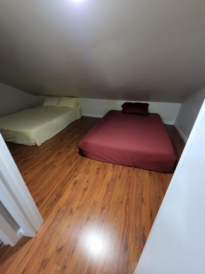 The bonus room upstairs near bathroom with 2 double beds.