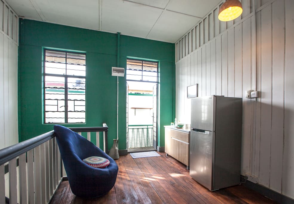 communal space with fridge & kitchen island (pathway to the bathroom)
