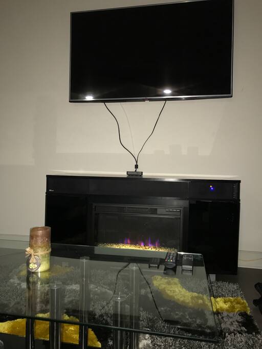 Mounted TV w/ Fireplace & Bluetooth Speakers