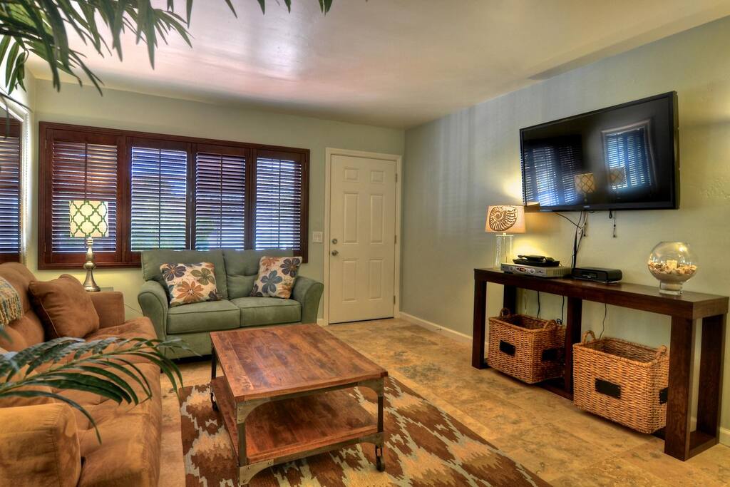 A large flat screen tv and comfy sofas in the living room