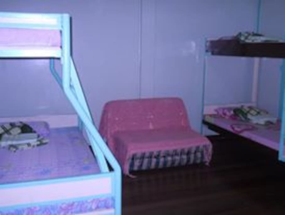 1 of the bedrooms. Each bedroom has 2 double deckers with pull out beds. Hence the house with 4 bedrooms can accommodate as much as 24 persons at a time. Extra mattresses can also be provided to accommodate about 30 persons.