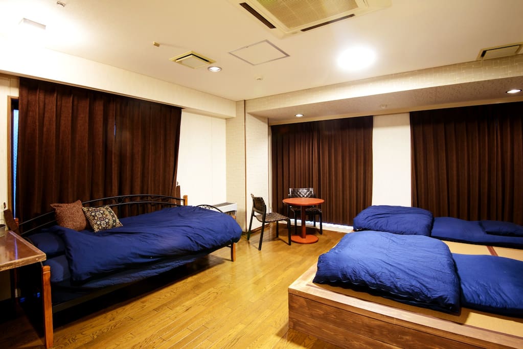 #202 During night, It offers a single bed and a work table and futons