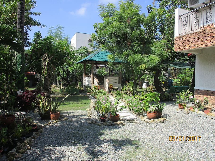 Our garden with a gazebo and bbq pit