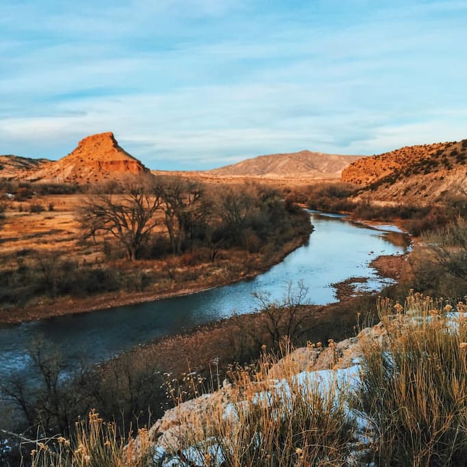 The yurt is located at the base of the mountain in the left of the photo, with the Chama River winding in the foreground