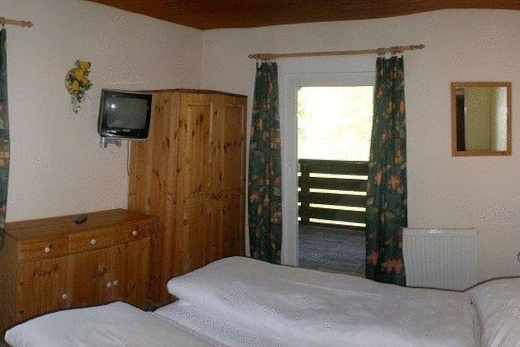 A guestroom with private bathroom,TV and balcony