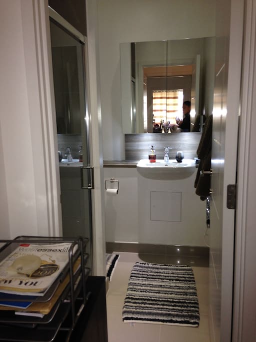 Large and modern shower room , sink with mirrored storage cupboard