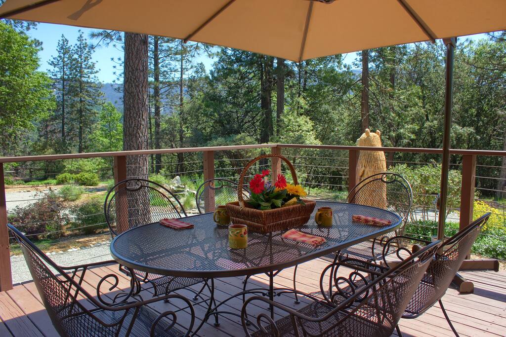 Sip coffee on wrap-around deck with new, Woodard patio furniture.