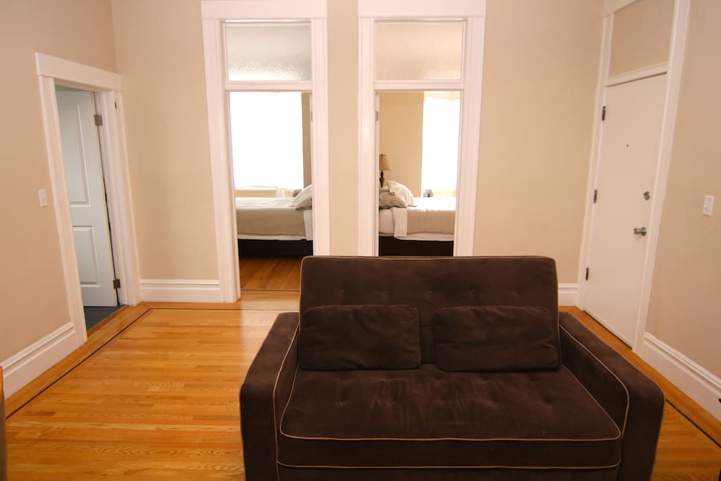 Living Room w/ View of both Bedrooms. This couch is also a pull -out couch.