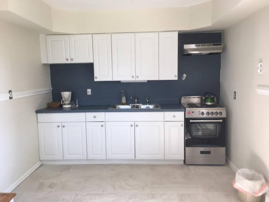 Large well lit kitchen with new porcelain tile floor and dinette