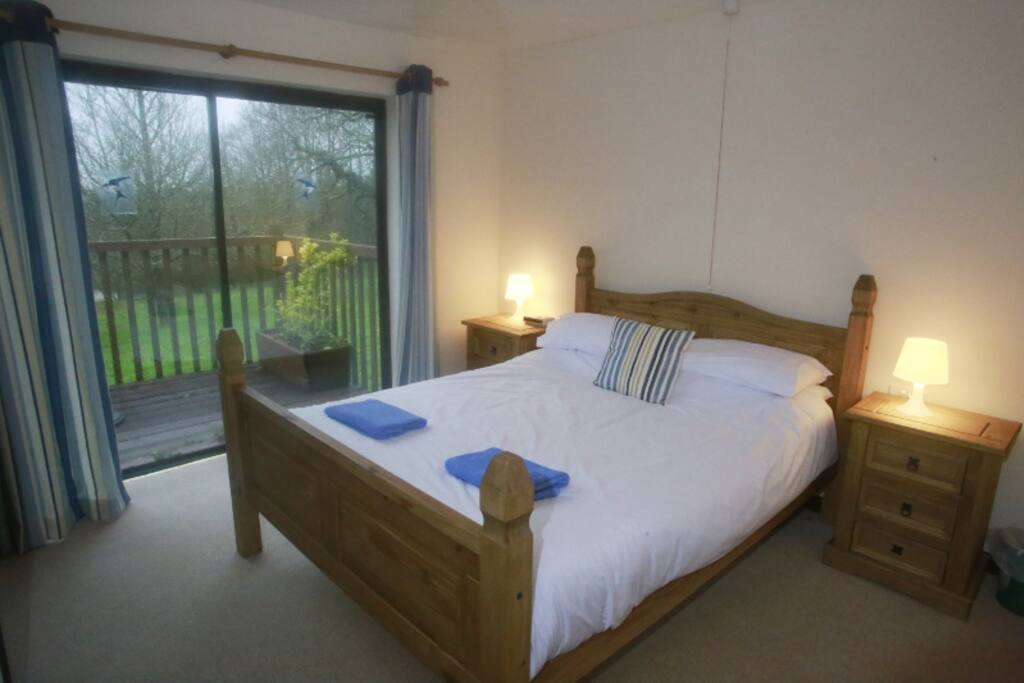 The master bedroom has a generous king-sized bed dressed with Egyptian cotton sheets. The balcony can be accessed through the patio doors.