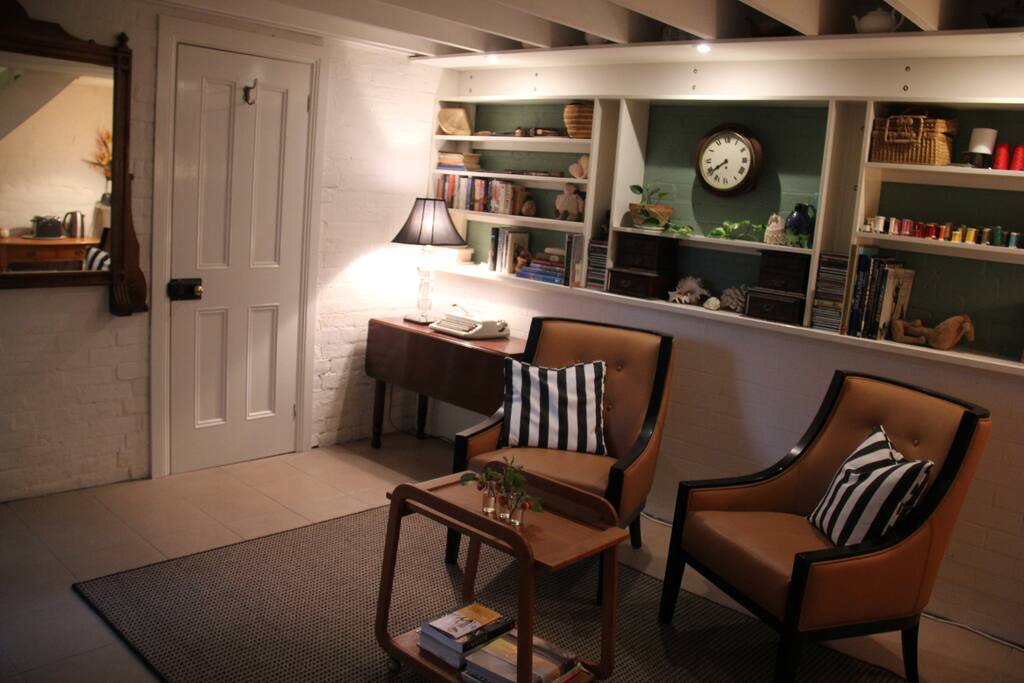 Stylish sitting area downstairs with door to private bathroom