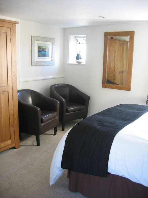 Room features TV, Tea & Coffee facilities and comfortable chairs.