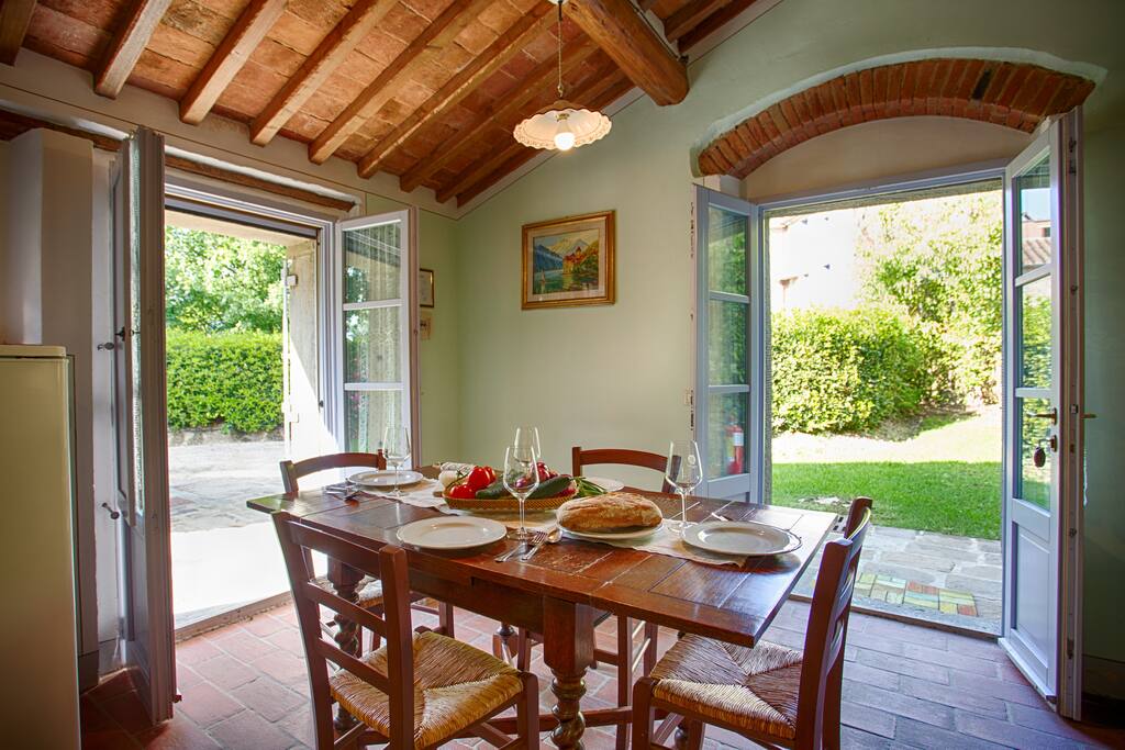 Dining area with doors opened to private garden space.