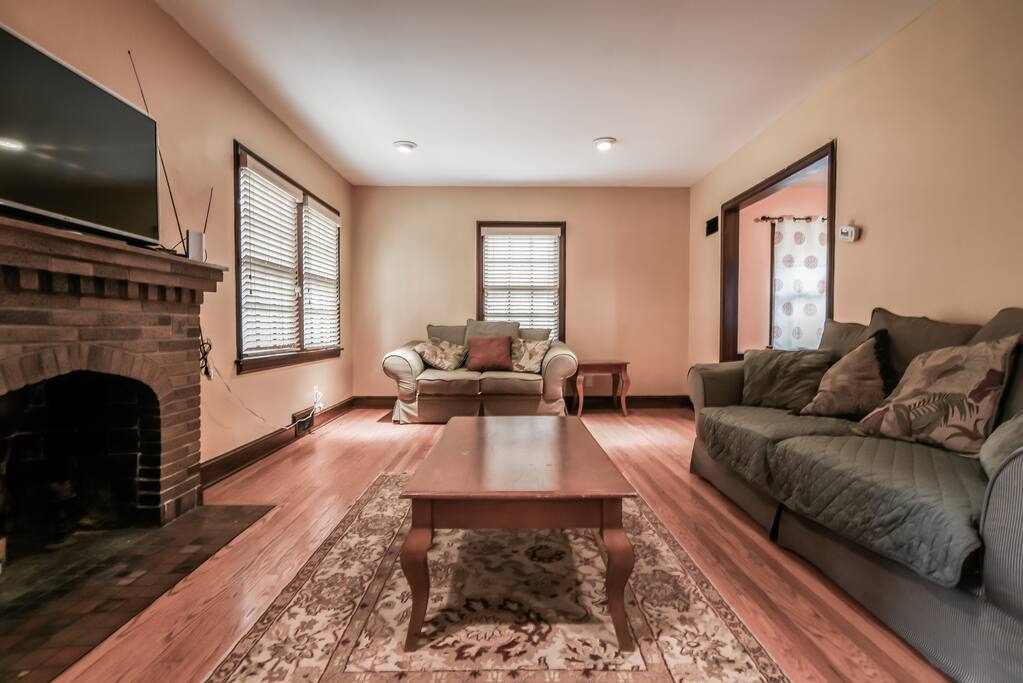 Living room with TV, fireplace, sofa, and loveseat.