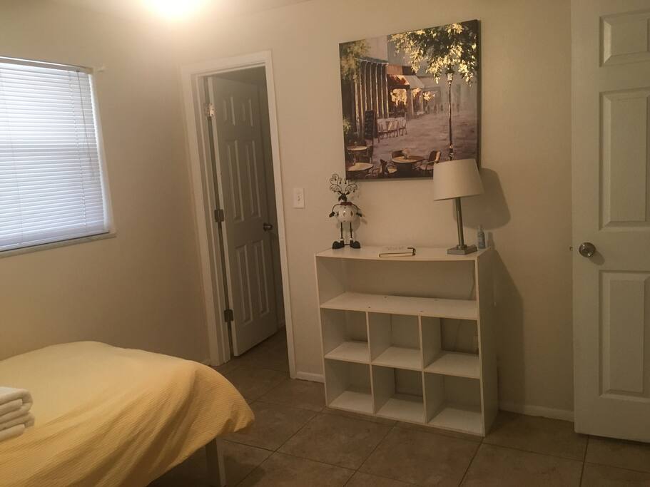 Shelf unit with a guest book on top! Entrance into walk in closet is the door on the left.