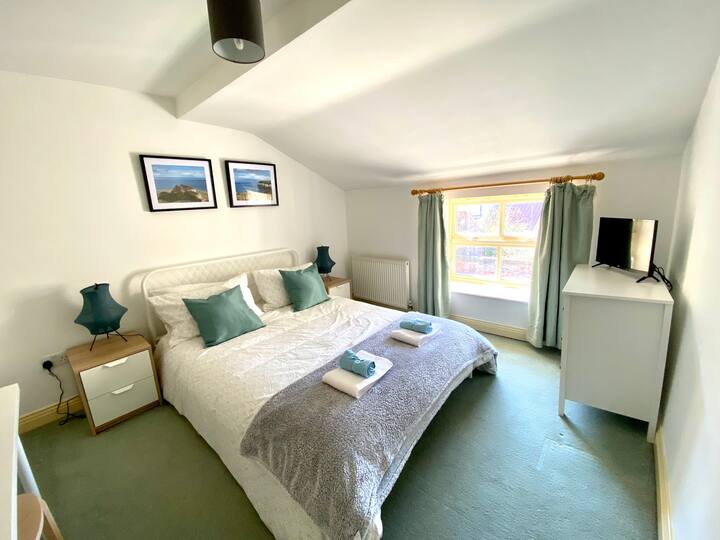 Kingsize-Bett, Smart-TV, Kleiderstange und Kommode (Rock Cottage).