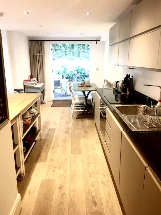 Open plan kitchen diner with french doors leading out to garden