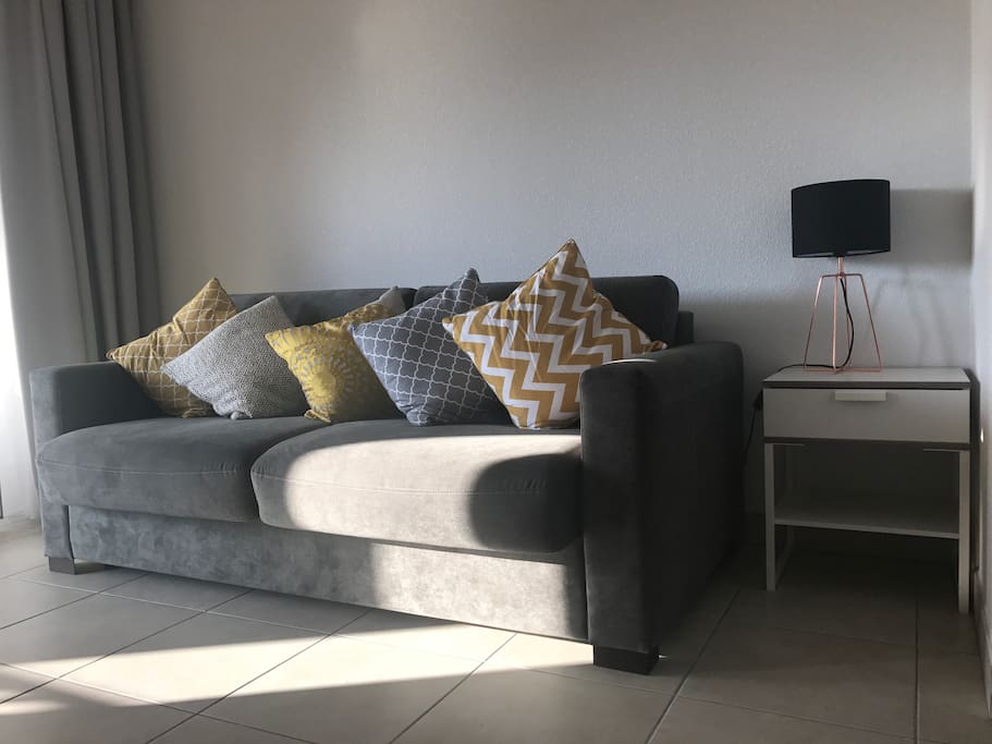 Light and airy lounge with big screen TV with local channels, Wi-Fi, Bluetooth speaker and patio doors to terrace