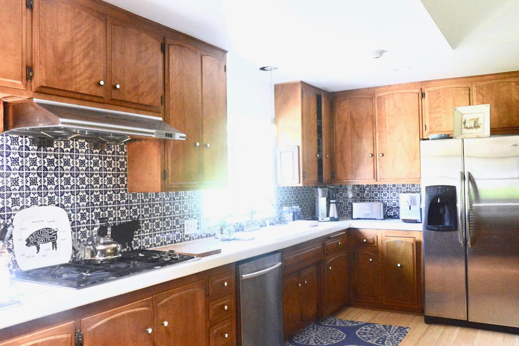 Enormous sunlit kitchen with full amenities including a coffee and cappuccino machine