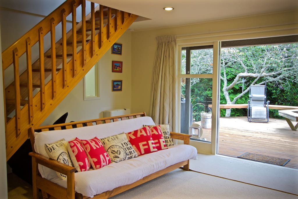 Comfy sofa and beanbags and great indoor/ outdoor flow.