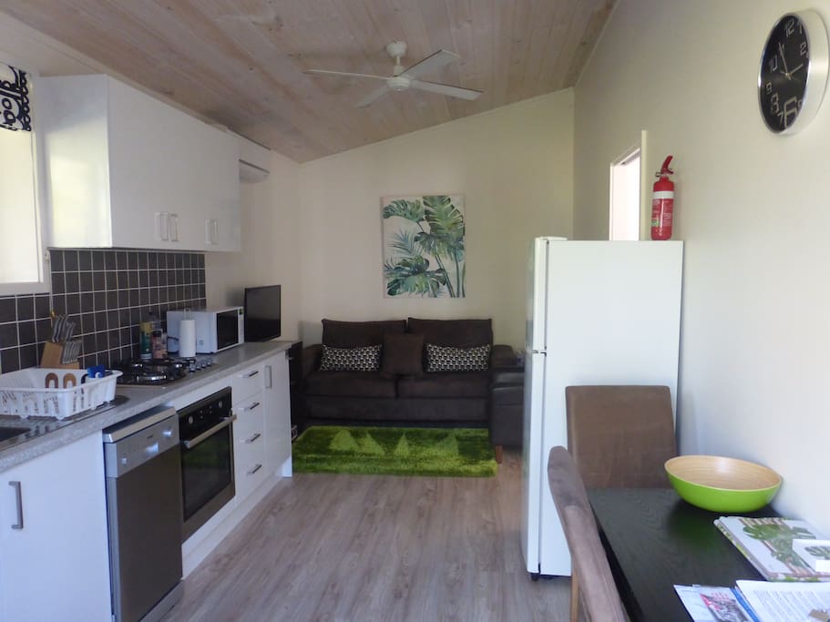 Sofa, armchair, TV with DVD and movies to choose from. Dining table.
