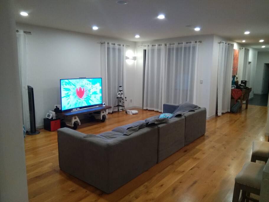 living room and it's huge smart TV linked up to satellite receiver.