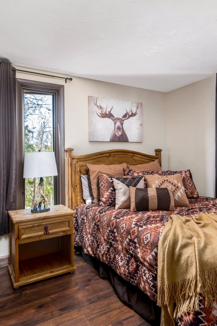 With a new mattress, linens, and furniture, the main floor private bedroom is a cozy retreat for the parents.