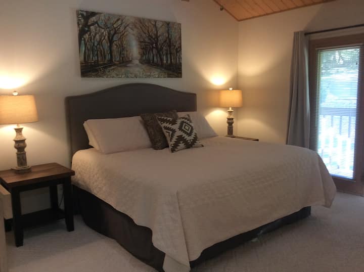The master bedroom is a large loft room with a private balcony overlooking the front yard and driveway.  The room offers a king size bed,  private bathroom with tub/shower combo and large walk in closet.  There is no actual door to close for privacy.