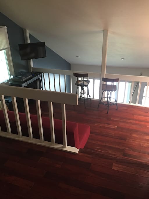 Loft area with futon, TV/cable, turntable with records, chairs