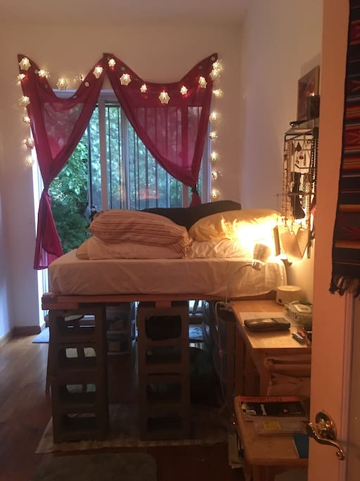 Bedroom w/ door leading directly to backyard