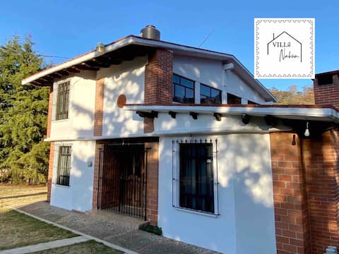 Country house surrounded by garden with fireplace