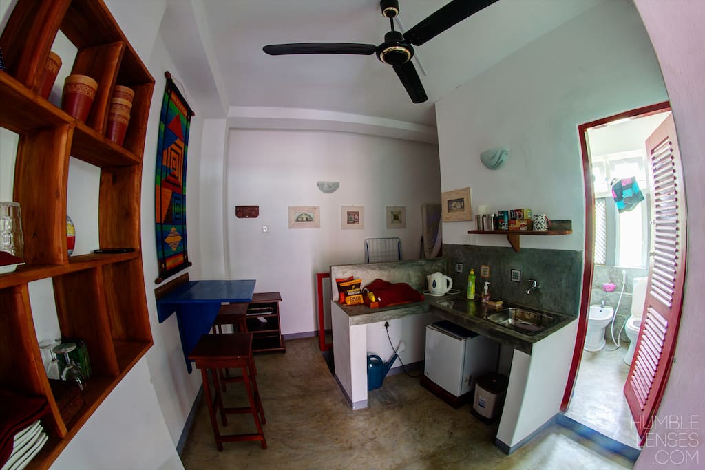 small kitchnette, with fridge, sink, table & 2 stool