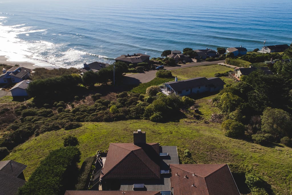 The home is located on a west-facing bluff overlooking the Pacific with ocean views from almost every room.