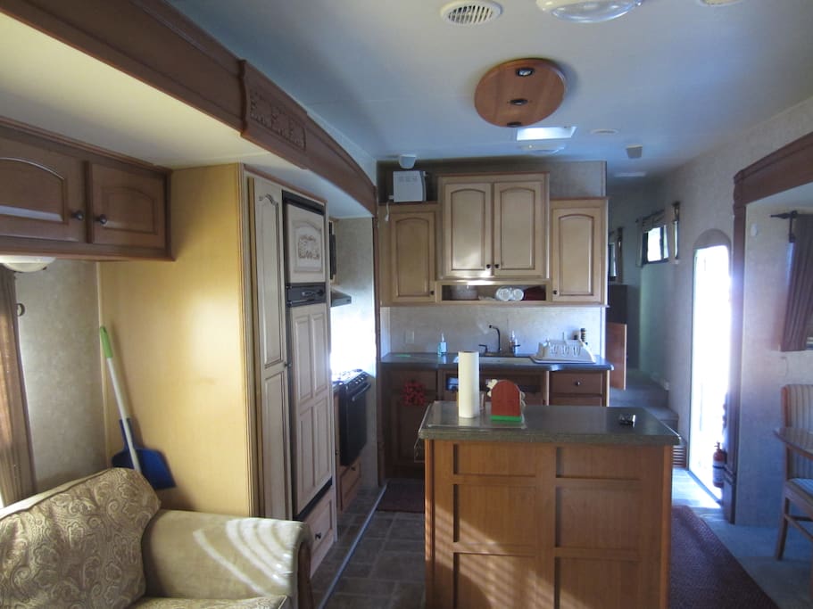 Kitchen with good size refrigerator, microwave, oven and stove top, K-Cup coffeemaker and toaster oven.