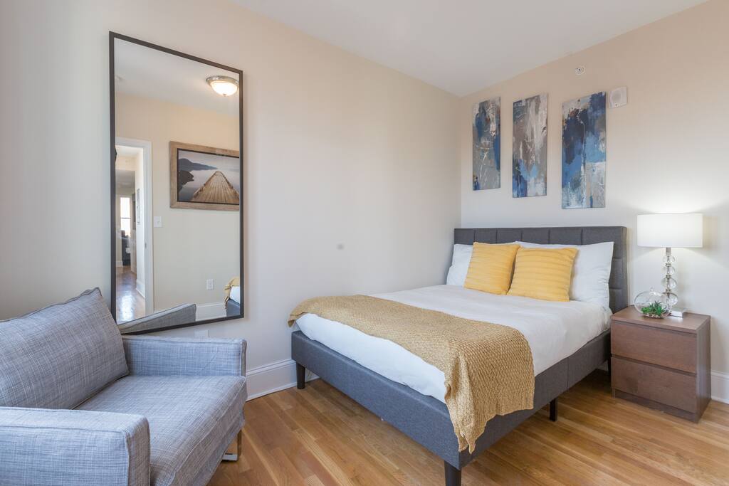 Master bedroom with couch and lots of natural light!